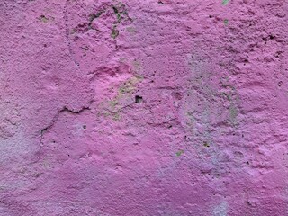 old worn and damaged pink concrete wall