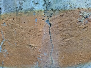old concrete wall with a crack in the middle