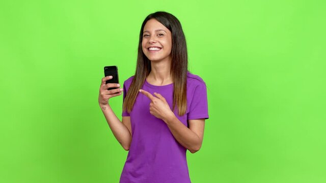 Young woman using mobile phone over isolated background