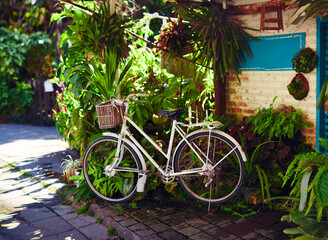 Parked retro bicycle with wicker baskets for tourist rent. Eco-friendly transport for the city.