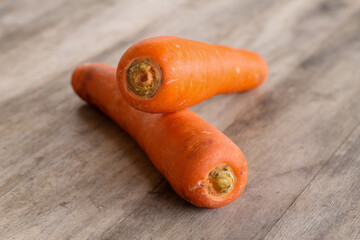 two carrots on an old wood background looks very beautiful