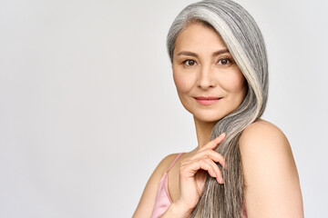 Portrait of gorgeous happy middle aged mature asian woman, senior older 50s lady pampering her hair...