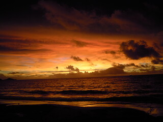 Fototapeta na wymiar Deep orange beach sunset 