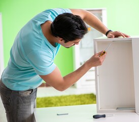 Man repairing furniture at home