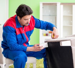 Repair contractor repairing broken furniture at home