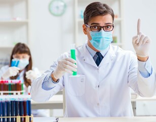 Naklejka premium Two chemists working in lab experimenting