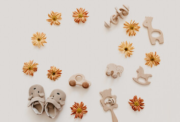 Newborn baby background. wooden toy with accessories for kids on beige background. Gender neutral. Organic and natural toys. Eco friendly plastic free toys for toddler.  Ecology zero waste