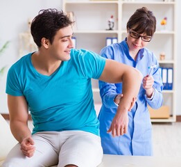 Doctor checking nerve reflexes with hammer