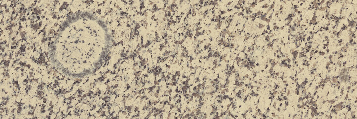 Granite texture. Natural granite with a grainy pattern. Stone background. Solid rough surface of rock. Durable construction and decoration material. Close-up.