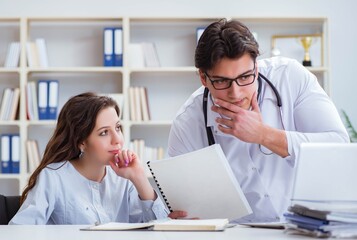 Female patient visiting male doctor for regular check-up in hosp