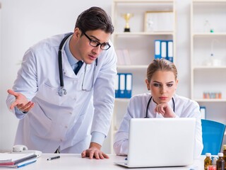 Male and female doctor having discussion in hospital