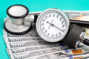 Stethoscope, sphygmomanometer and cash money. Healthcare, health insurance and medical bills...