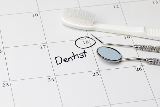 Dentist Appointment Reminder On Calendar With Toothbrush And Dental Tools. Concept Of Oral Health, Dental Exam And Teeth Cleaning