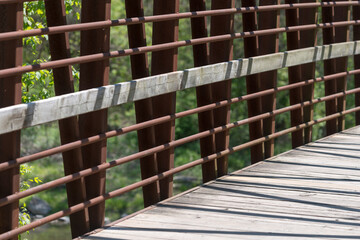 detail of a rusty metal and wood foot bridge