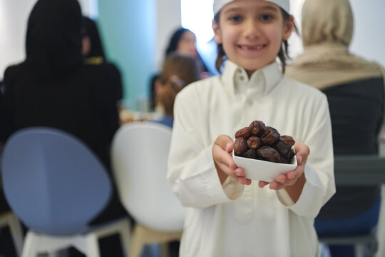 Arabian kid in the traditional clothes during iftar