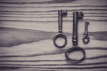 Iron keys on a textured wooden table, background - 434011468