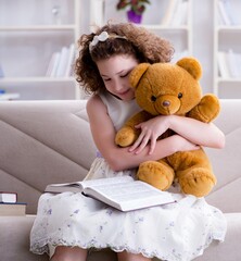Little pretty girl reading books at home