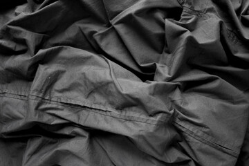 unpressed dark grey black casual dress shirt with seams - photographed from above with low or...