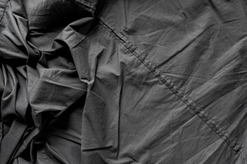 unpressed dark grey black casual dress shirt with seams - photographed from above with low or...