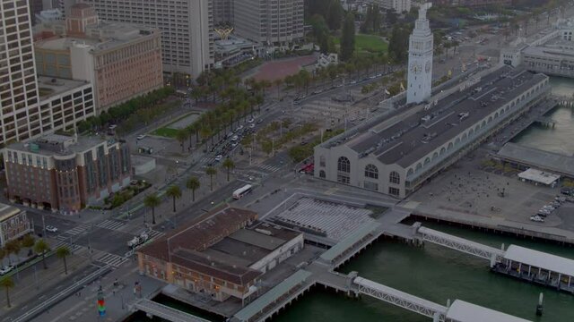 Cinematic aerial drone footage of the Embarcadero, the Financial District and the San Francisco City Skyline during sunset - California USA