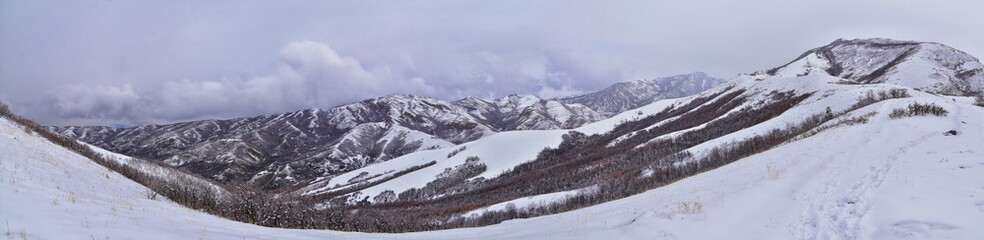 Obraz premium Little Black Mountain Peak hiking trail snow views winter via Bonneville Shoreline Trail, Wasatch Front Rocky Mountains, by Salt Lake City, Utah. United States.