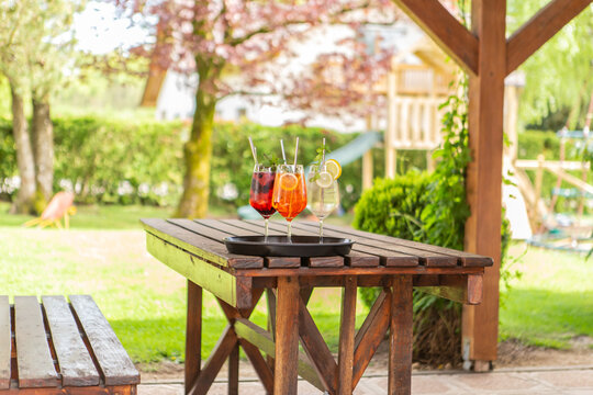 Close-up of delicious alcoholic summer cocktails on a wooden table in the summer outdoors