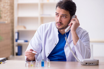 Young male doctor in vaccination concept