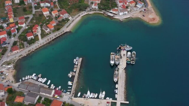 Fishing Trawlers With Small Boats Moored On Marina Of Kali In Ugljan Island, Zadar, Croatia. - aerial
