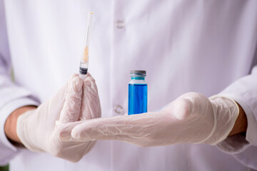 Young male doctor in vaccination concept
