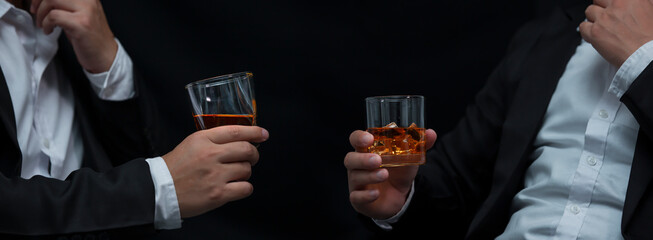 Closeup businessmen holding a glass of whiskey