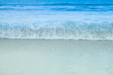 The beautiful beach. White sandy beach, sea wave, blue sky and sun shine.