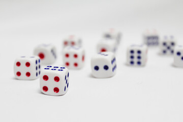selective focus of spread of dice on white background. high key photography.