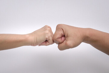 Close up shot of fist bump against white background.