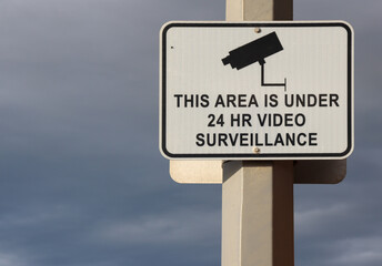 security surveillance sign against sky