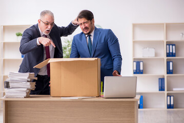 Two male employees in dismissal concept