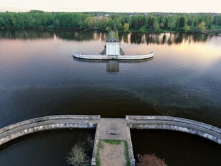 Aerial view sunset on the river. Colorful clouds are reflected in the water. Beautiful panorama of nature at sunset.