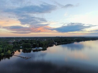 Aerial view sunset on the river. Colorful clouds are reflected in the water. Beautiful panorama of nature at sunset.