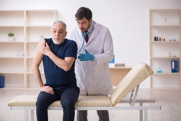 Old male patient visiting young male doctor in vaccination conce