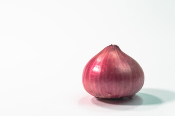 Red whole onion its slightly sweeter flavor finishes Healthy organic pomegranate..Shallots in white background.studio shot..