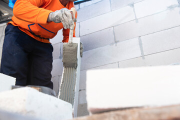 Professional workers use plaster to glue walls in private homes. Masonry, repair and foam construction