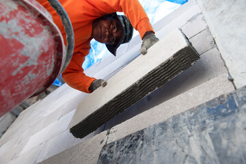Professional workers use plaster to glue walls in private homes. Masonry, repair and foam...