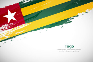 Brush painted grunge flag of Togo country. Hand drawn flag style of Togo. Creative brush stroke concept background