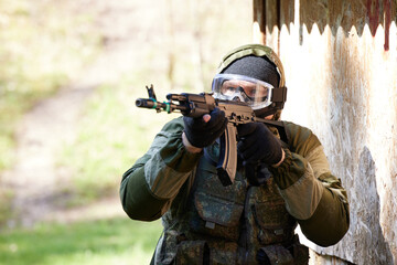 male soldier fighting in military uniform outdoors aiming and shooting