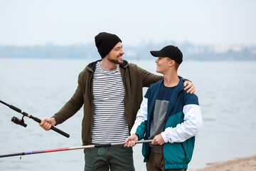 Father and son fishing together on river