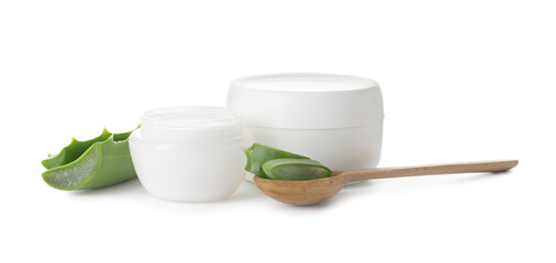 Jars of natural cream and spoon with aloe pieces on white background