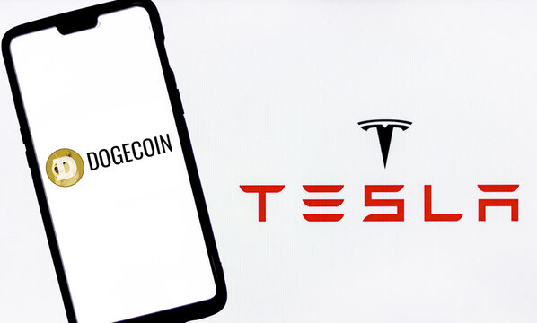 Kathmandu, Nepal - May 12 2021: Dogecoin logo on a smartphone against Bitcoin logo in the background.