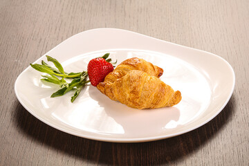Sweet croissant in the plate