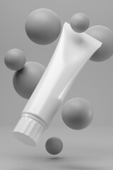 Blank white cosmetic tube on gray background.
