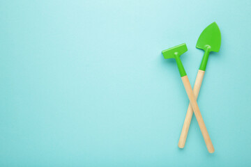 Gardening tools on blue background with copy space.