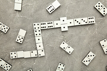 Domino pieces on the grey background. Macro photo